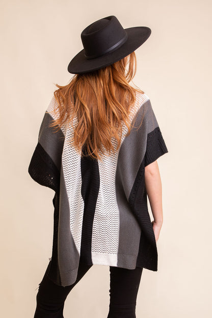 Stylish boho knit poncho for women in black, white, and gray with a relaxed fit