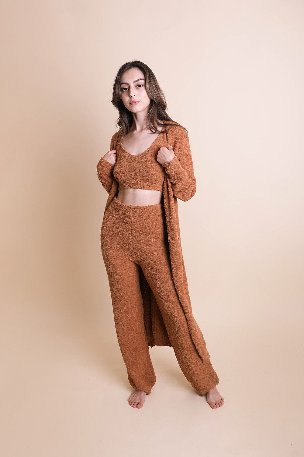 Model wearing a boho longline cardigan in brown with matching crop top and pants for a cozy look