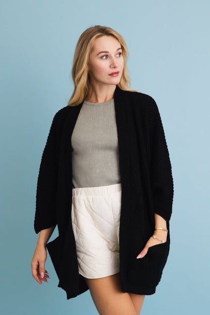 Leto Collection boho ribbed knit cardigan in black, styled over a gray top and white shorts