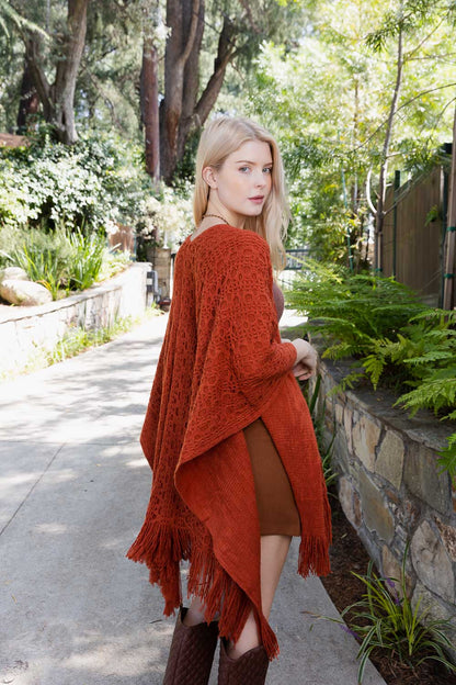 Rust-colored boho tassel wrap poncho with open design and fringed edges for stylish layering