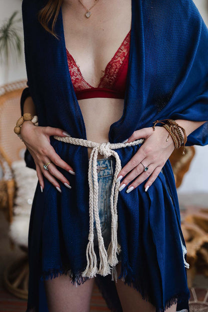 Woman wearing a navy garment with a boho braided rope belt, styled for a trendy look