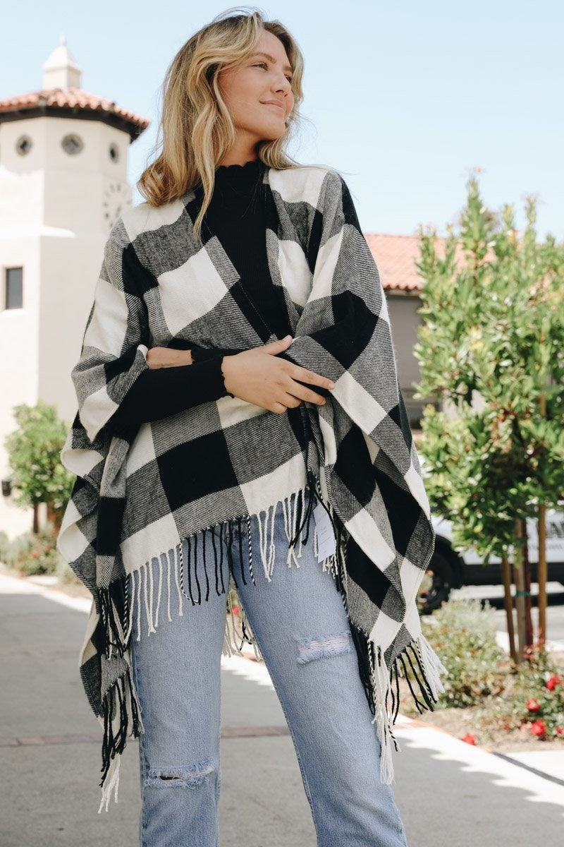 Stylish buffalo check ruana from Leto Collection featuring fringe detail and a cozy fit