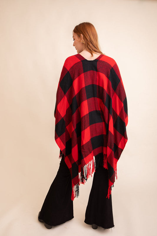 Leto Collection buffalo check tassel ruana with a red and black plaid pattern and fringed edges