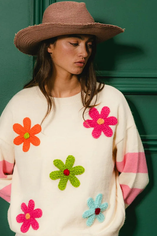 Colorful floral sweater for women featuring vibrant flower appliqués and playful stripes