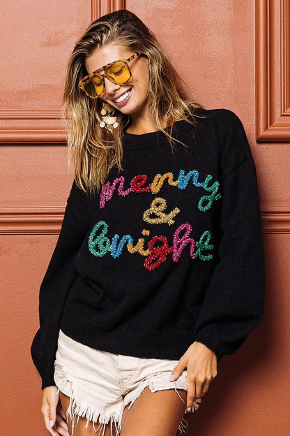 Trendsi tinsel lettering Christmas sweater in black with colorful 'Merry & Bright' design
