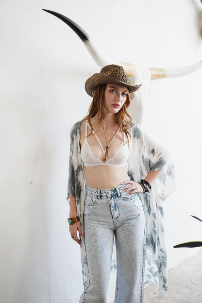 Leto Collection boho cross strap lace bralette paired with a kimono and flared jeans for a trendy look