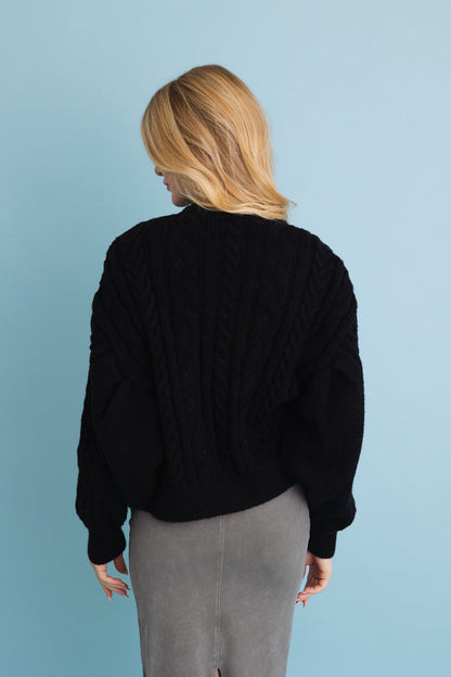 Leto Collection chunky cable knit cropped cardigan in black for a cozy, stylish look