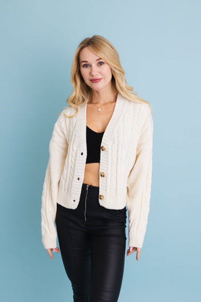 Leto Collection chunky cable knit cropped cardigan in cream for stylish layering with high-waisted bottoms