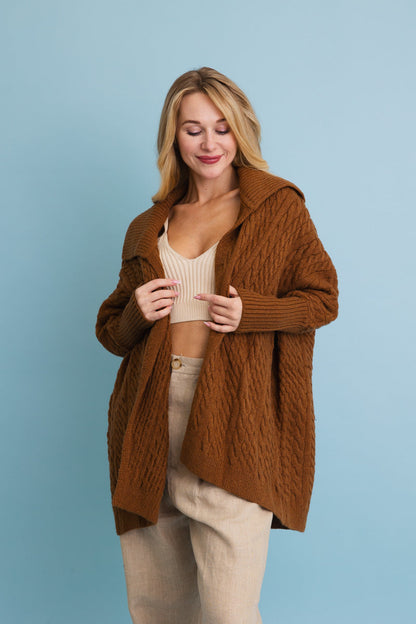 Leto Collection chunky cable knit poncho cardigan in warm brown with a cozy hood and relaxed fit