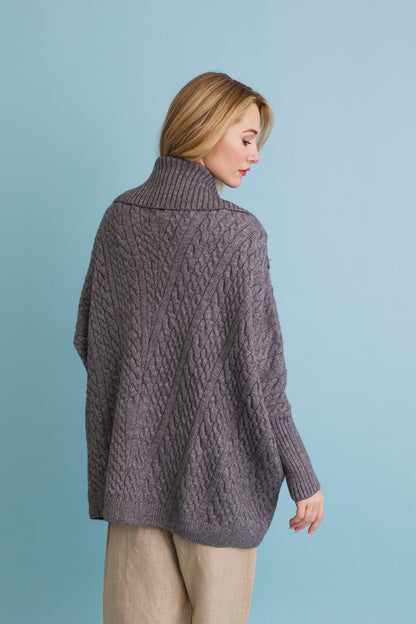 Stylish gray chunky cable knit poncho cardigan with a high collar and relaxed fit