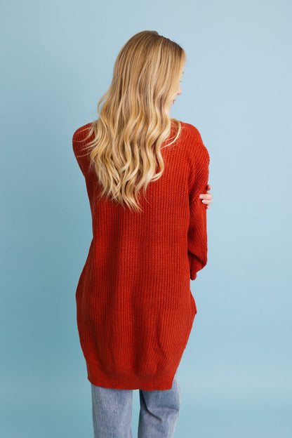 Cozy waffle knit cardigan in rust color with a relaxed fit and long sleeves for comfort and style