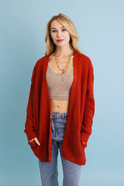 Leto Collection cozy waffle knit cardigan in rust color worn over a stylish crop top with jeans