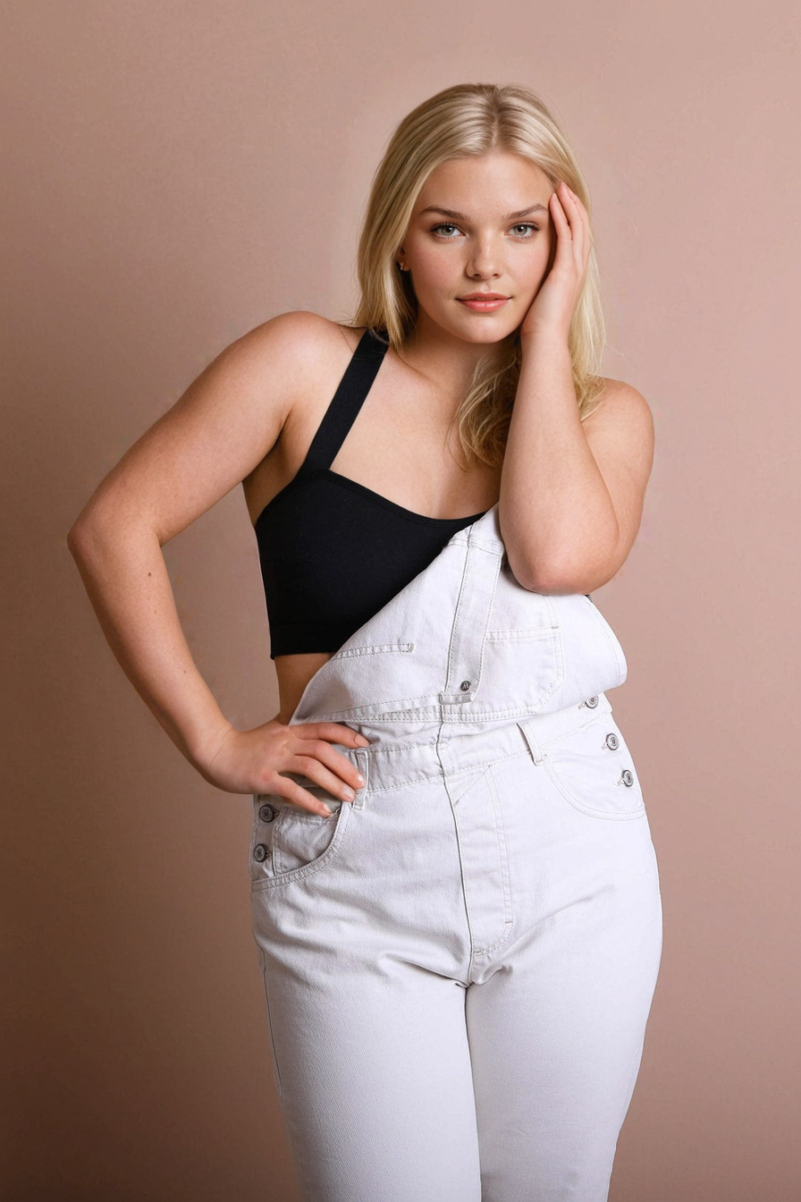 Leto Collection plus size cross front bralette in black, styled with white overalls for a trendy look