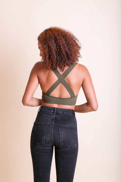 Back view of Leto Collection boho cross strap bralette in olive green, styled with high-waisted jeans
