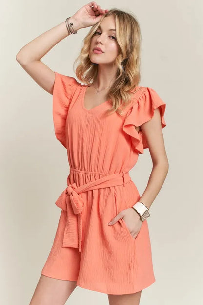 Trendsi boho ruffle sleeve romper in coral with a cinched waist and side pockets for a stylish summer look