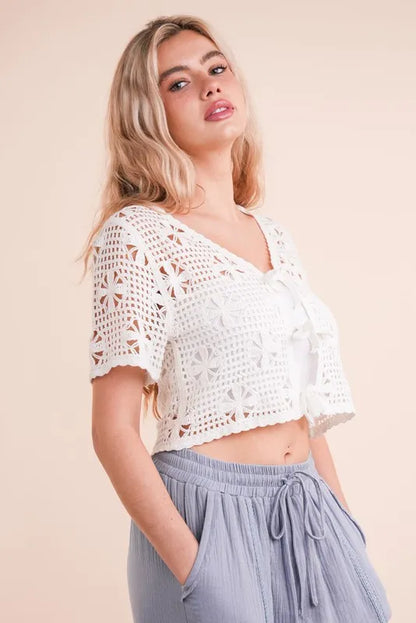 Trendsi crochet front tie crop top in white, featuring floral patterns and short sleeves