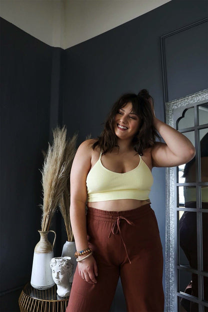 Plus size dream catcher bralette in soft yellow, styled with comfy brown pants for a relaxed look