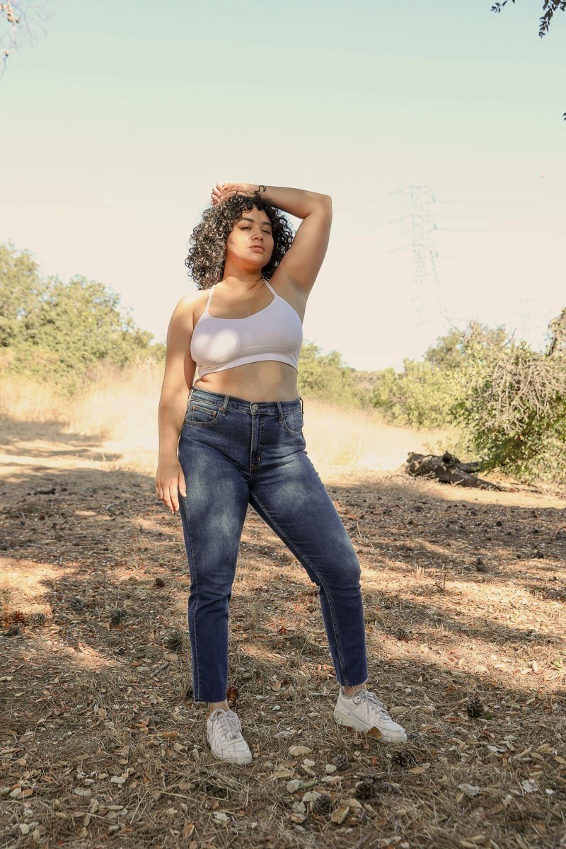 Plus size dream catcher bralette in pink paired with high-waisted jeans for a stylish outdoor look