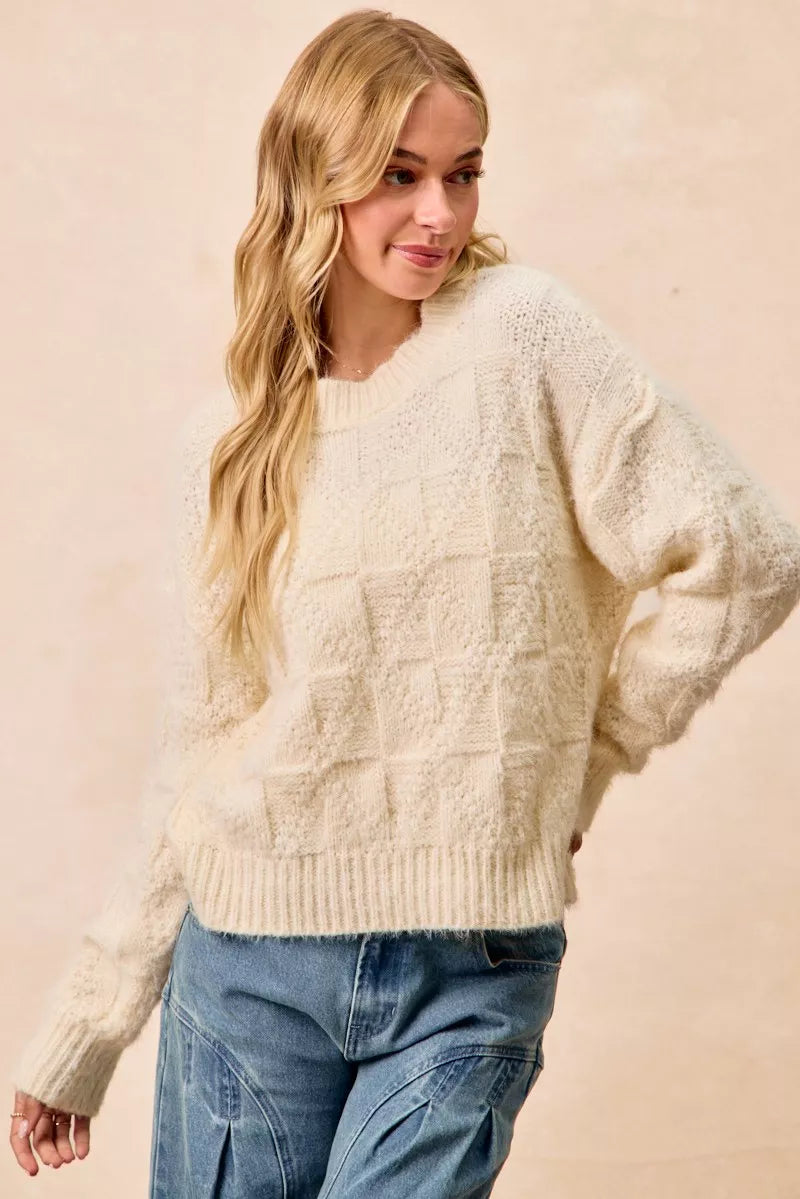 Cozy checker board drop shoulder sweater in cream with a relaxed fit and textured pattern
