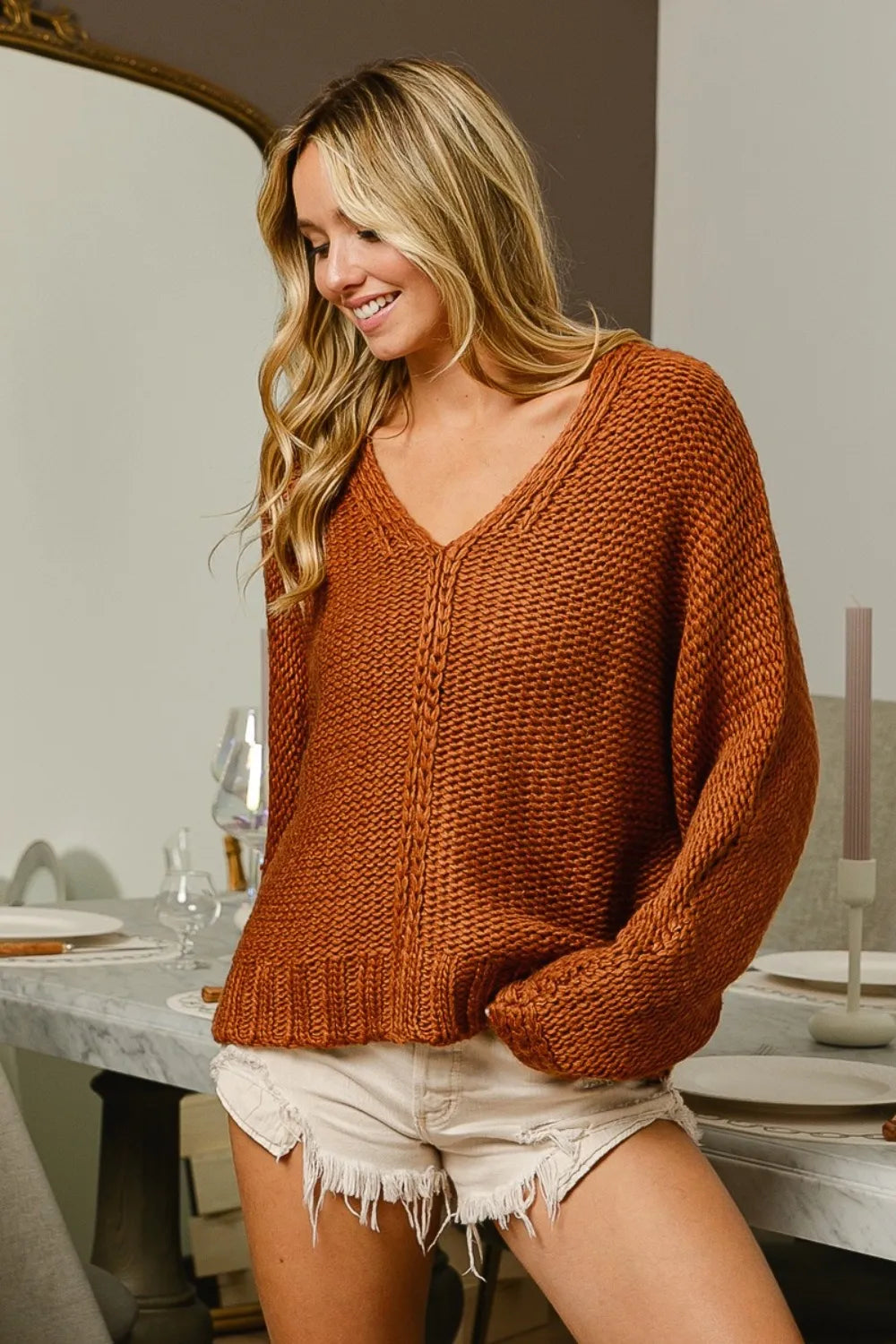 Trendsi boho V-neck cable knit sweater in warm orange paired with shorts for a chic look