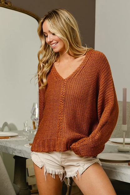 Trendsi boho V-neck cable knit sweater in warm orange paired with shorts for a chic look