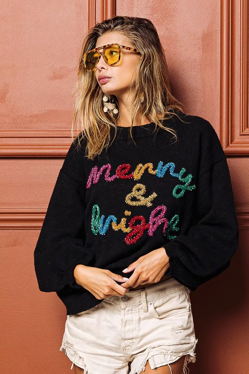 Black Christmas sweater featuring tinsel lettering Christmas sweater design with colorful text