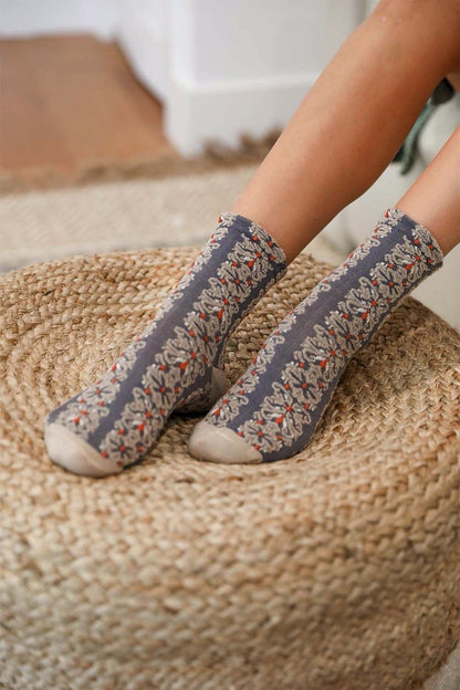 Leto Collection boho embroidered flower socks in gray with colorful floral designs on cozy background