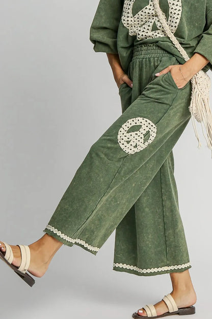 Trendsi plus size boho wide leg pants in green with peace sign and lace trim details