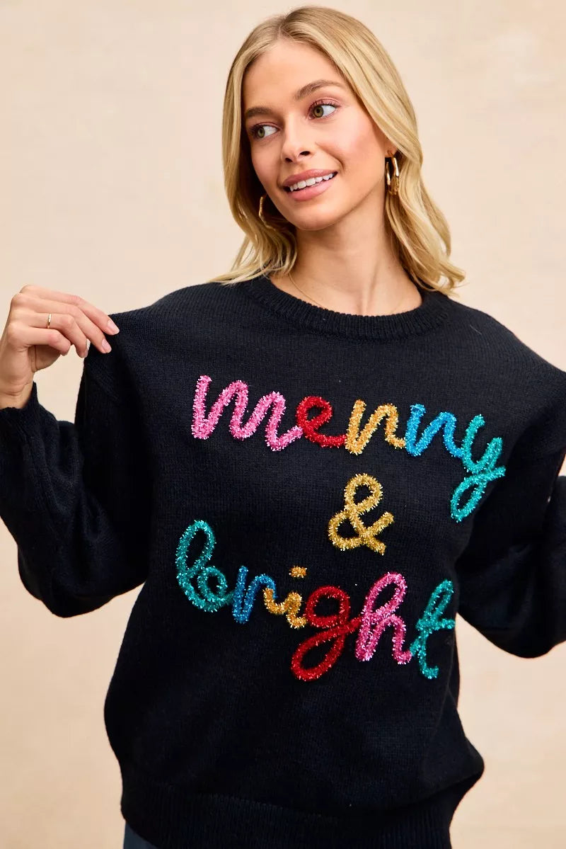 Cozy black Christmas sweater featuring tinsel lettering Christmas sweater design with 'merry & bright' text