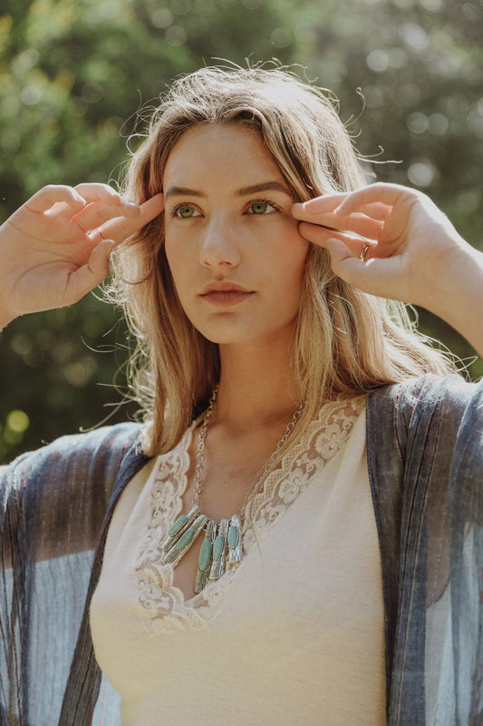 Model wearing turquoise pendant Boho Necklace, Boho Chic Jewelry, Spiritual from Leto Collection layered with lace top