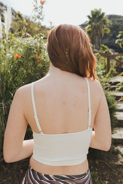 Leto Collection high neck mesh lace bralette in a soft fabric with adjustable straps on a model outdoors