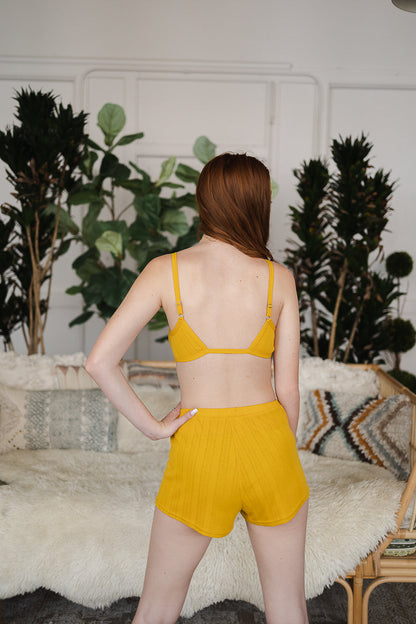 Back view of Leto Collection pointelle lounge bralette in yellow paired with matching shorts