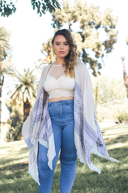Plus size high neck lace bralette paired with a flowing kimono and high-waisted jeans in a sunny outdoor setting