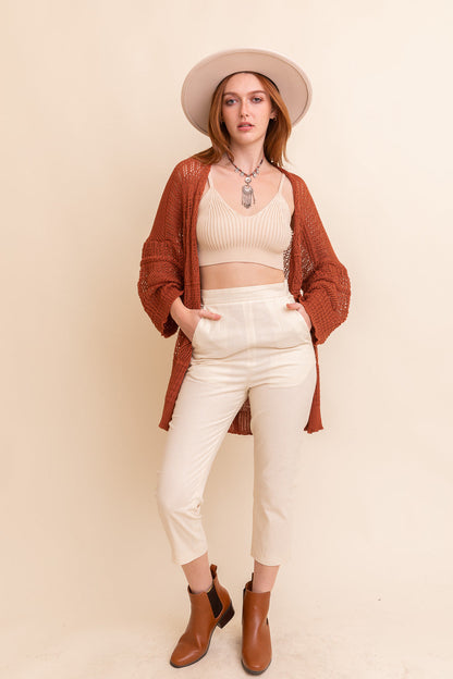 Leto Collection boho knit cardigan in rust color styled with a cropped top and high-waisted pants