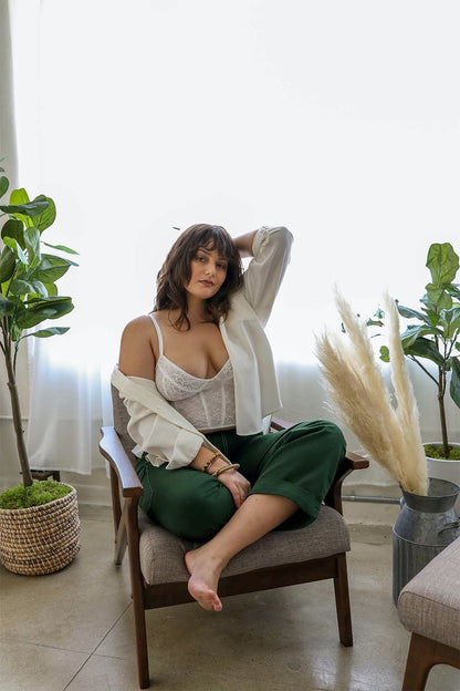 Leto Collection lace longline corset bralette plus size in a cozy setting with greenery