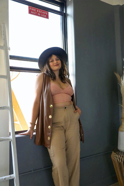 Plus size lace longline corset bralette from Leto Collection styled with a brown vest and wide-leg trousers