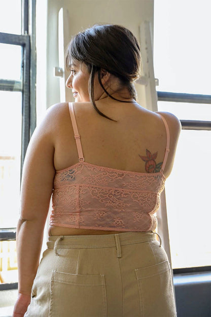 Plus size lace longline corset bralette in soft pink, showcasing a delicate lace design and adjustable straps