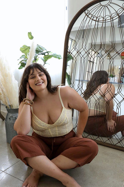 Leto Collection Lace Longline Corset Bralette Plus Size in Cream, stylishly worn with relaxed pants