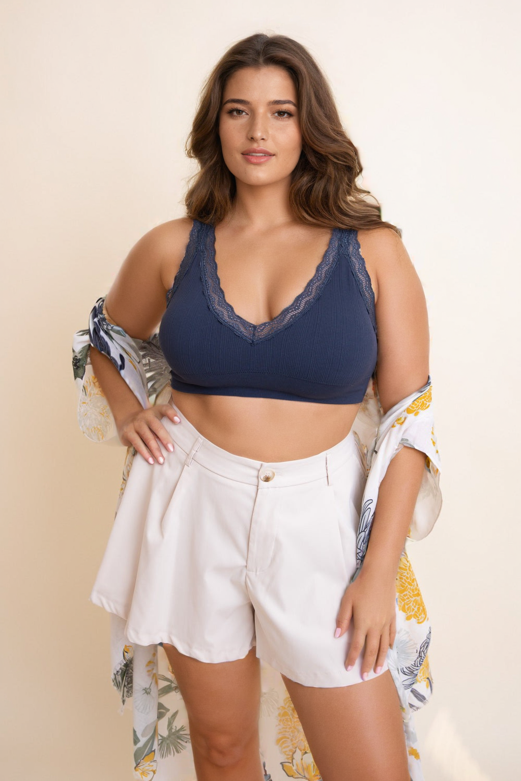 Plus size lace bralette in navy with adjustable straps and lace trim, styled with white shorts