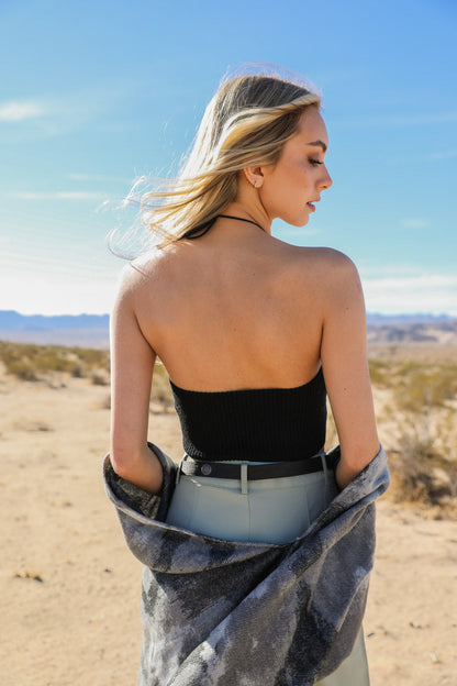Stylish model wearing a lace-up halter knit bralette with a scenic desert backdrop