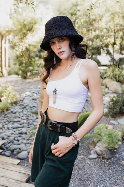 Leto Collection offset shoulder brami top in white, styled with a bucket hat and accessories