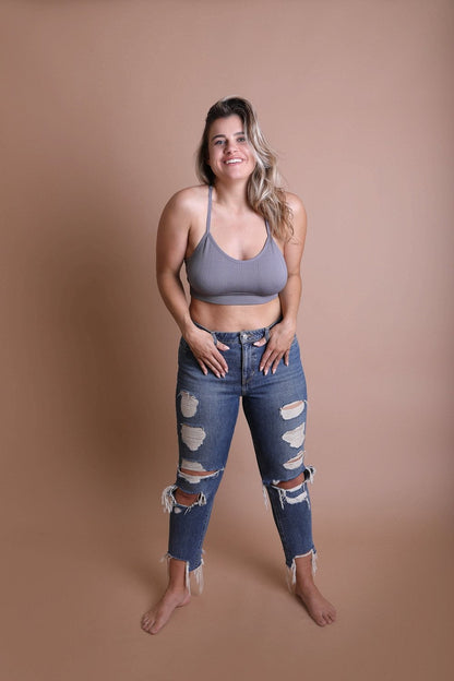 Leto Collection plus size tattoo back bralette in gray paired with distressed blue jeans