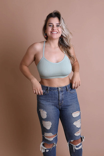 Leto Collection plus size tattoo back bralette in light green paired with distressed jeans