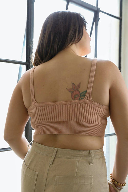 Back view of a Leto Collection rib knit brami top in soft peach color with adjustable straps