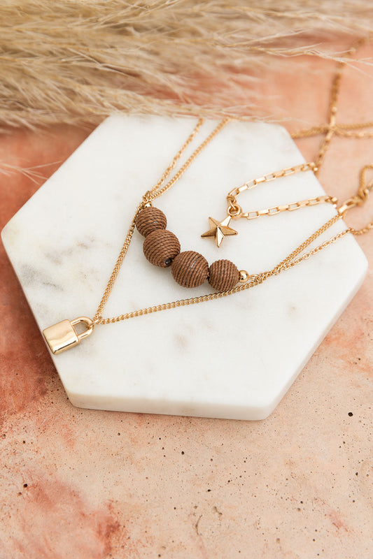 Leto Collection layered gold necklaces with wooden beads star and padlock charms Boho Necklace, Boho Chic Jewelry, Spiritual