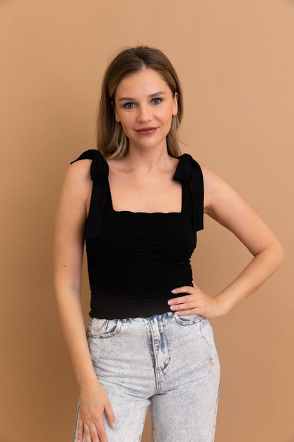 Black seamless smocked tie shoulder top from Leto Collection with stylish straps and a fitted design