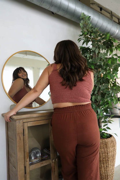 Plus size boucle brami from Leto Collection, stylishly worn with loose pants in a cozy setting