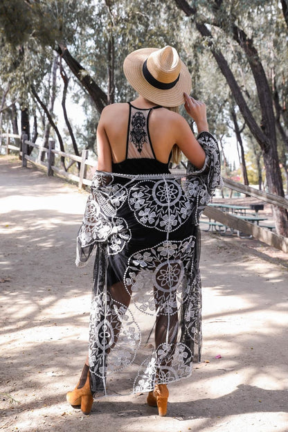 Boho tattoo back slip dress from Leto Collection styled with a shawl and hat in a sunny outdoor setting