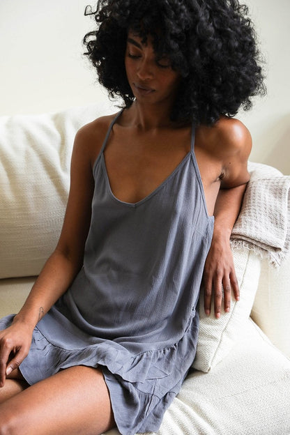 Model wearing a boho tattoo back slip dress in gray, featuring a relaxed fit and ruffled hem