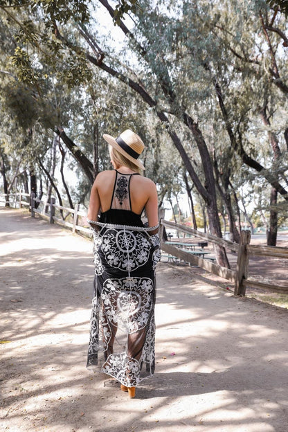 Leto Collection boho tattoo back slip dress flowing gracefully in a sunlit outdoor setting